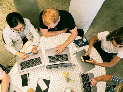 Top view of diverse team collaboratively working in a modern office setting.
